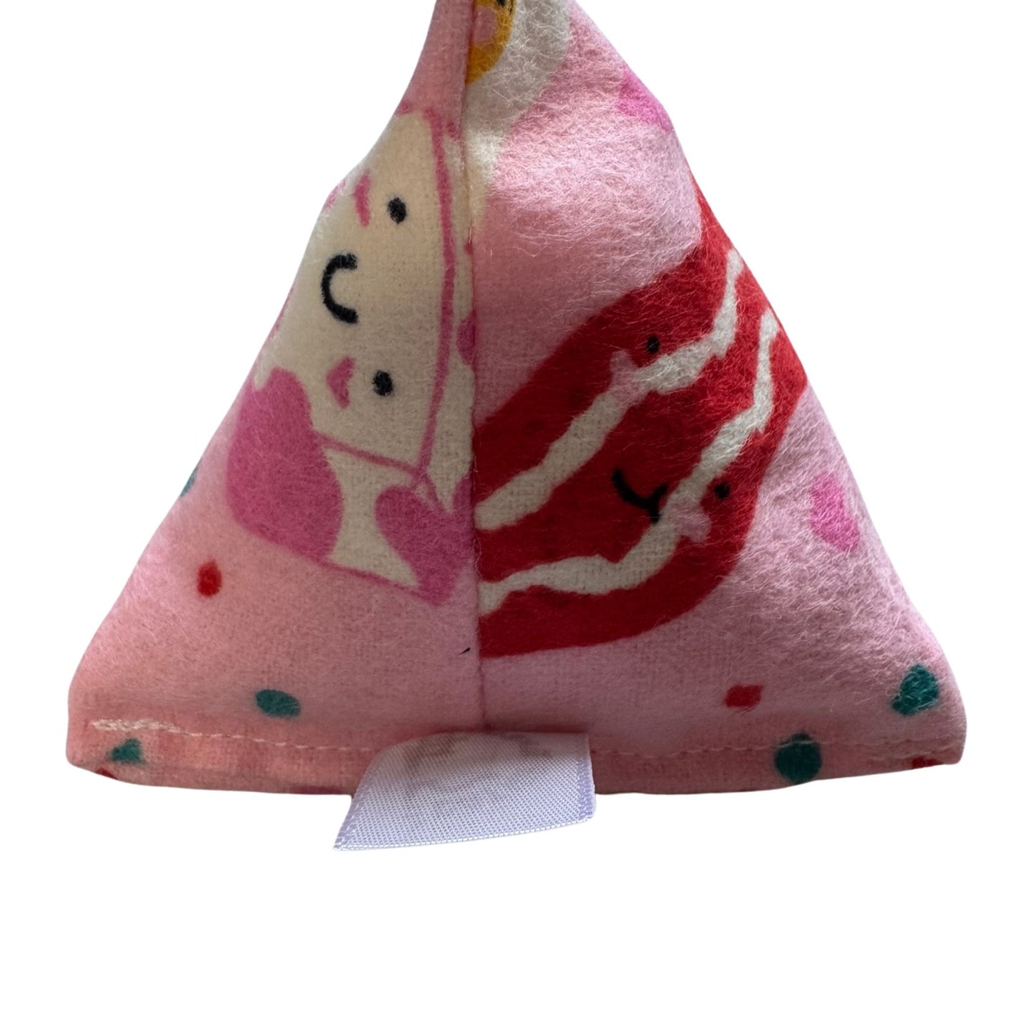 A triangular pink Happy Sack catnip toy featuring a bacon and smiley face design, perfect for cats to bat, pounce, and roll made by CatnipTakeout