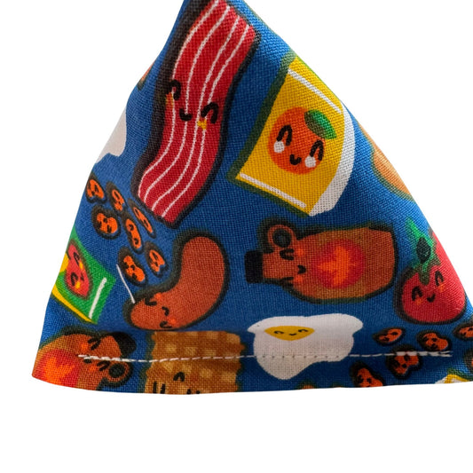 A triangular blue Happy Sack catnip toy with brunch-themed prints, including bacon, eggs, and syrup bottles, designed for playful cats made by CatnipTakeout.