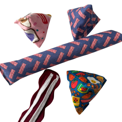 A complete bundle featuring a Bacon Kicker toy, Classic Bacon Strip toy, and Happy Sacks in bacon and brunch-themed designs, ideal for playful cats made by CatnipTakeout