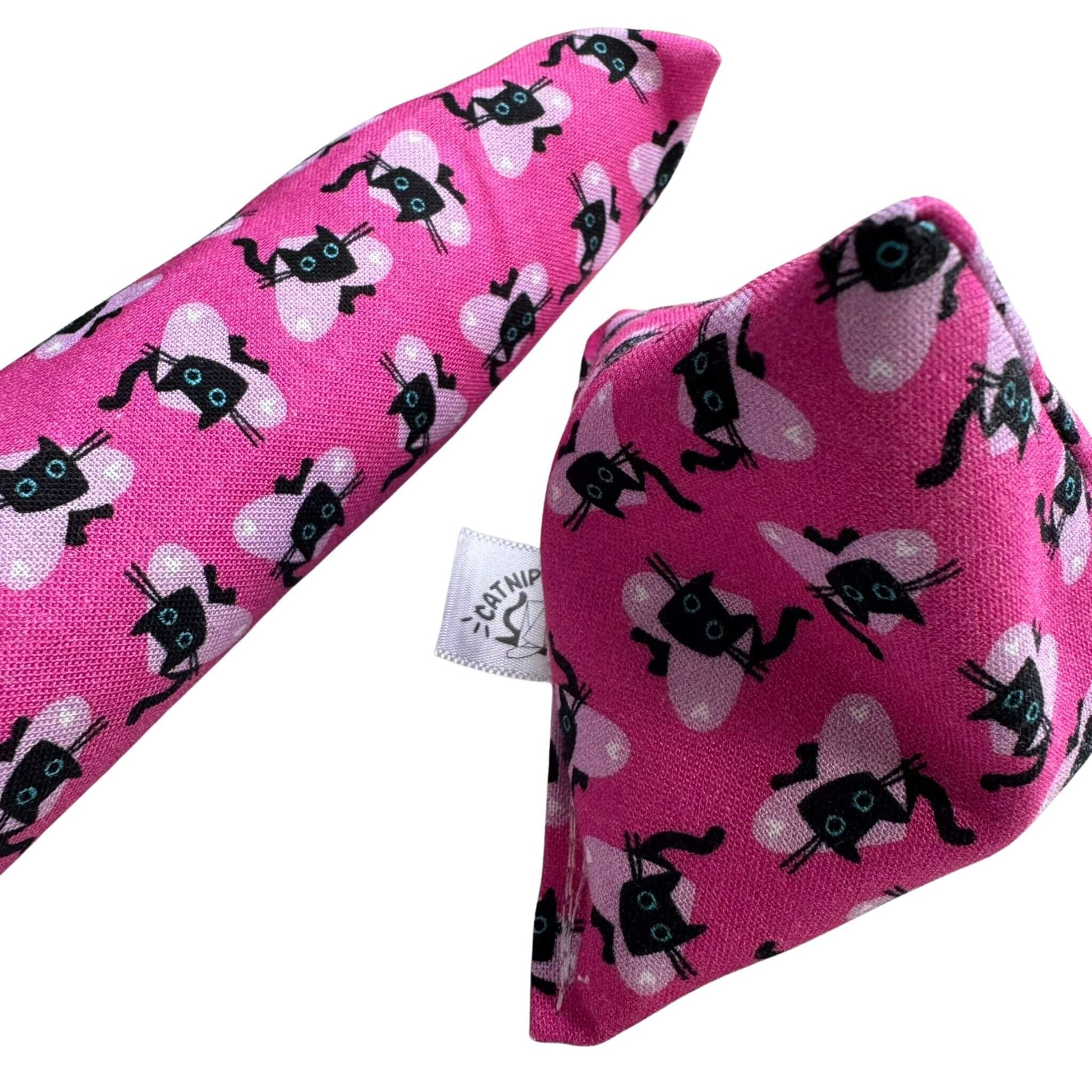 A pink Valentine’s catnip kicker toy 
 and Happy Sack cat toy featuring black cats with heart-themed details, ideal for pouncing and kicking made by CatnipTakeout.