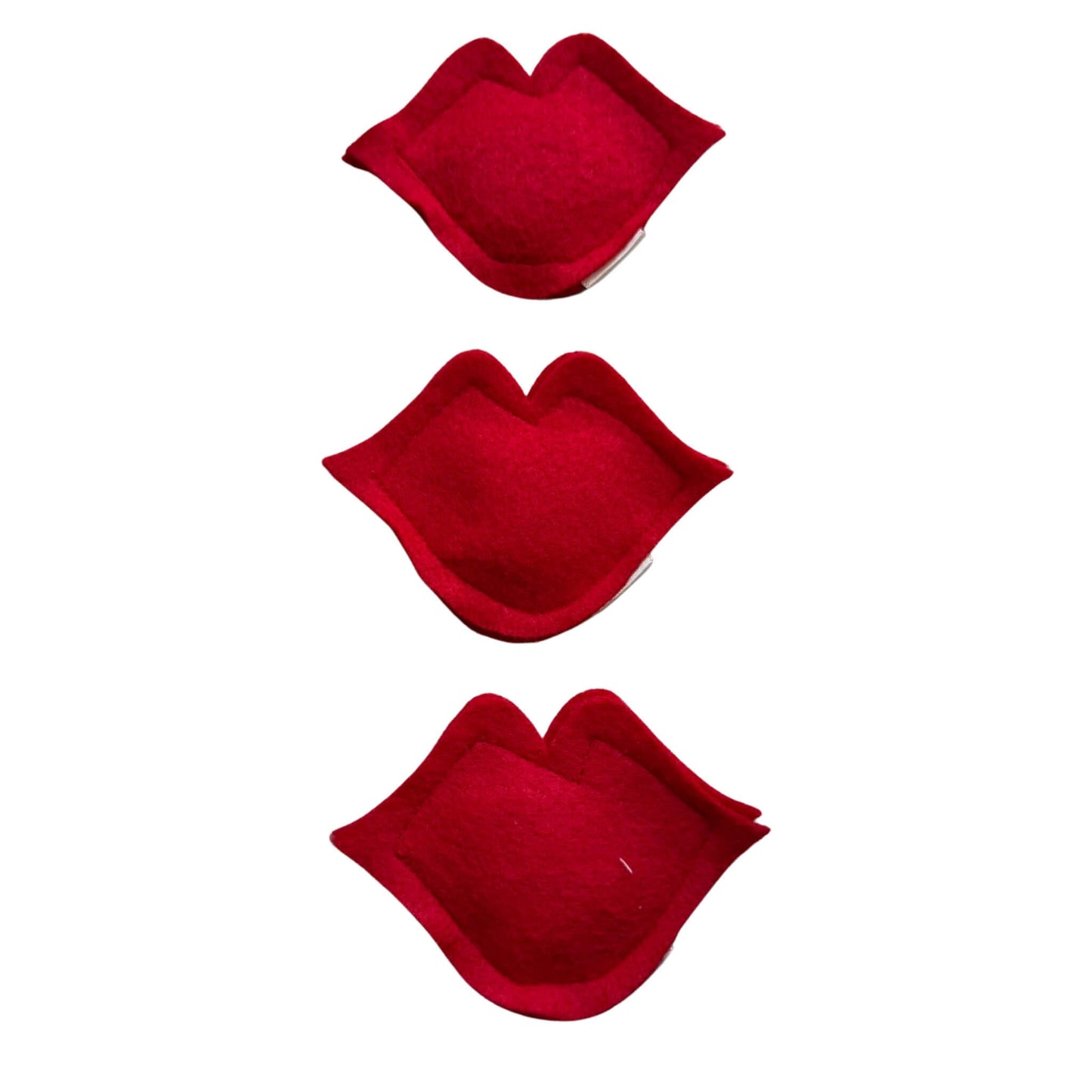 Group of red lips-shaped catnip toys made from soft felt, filled with organic catnip, perfect for playful cats on Valentine’s Day made by CatnipTakeout.