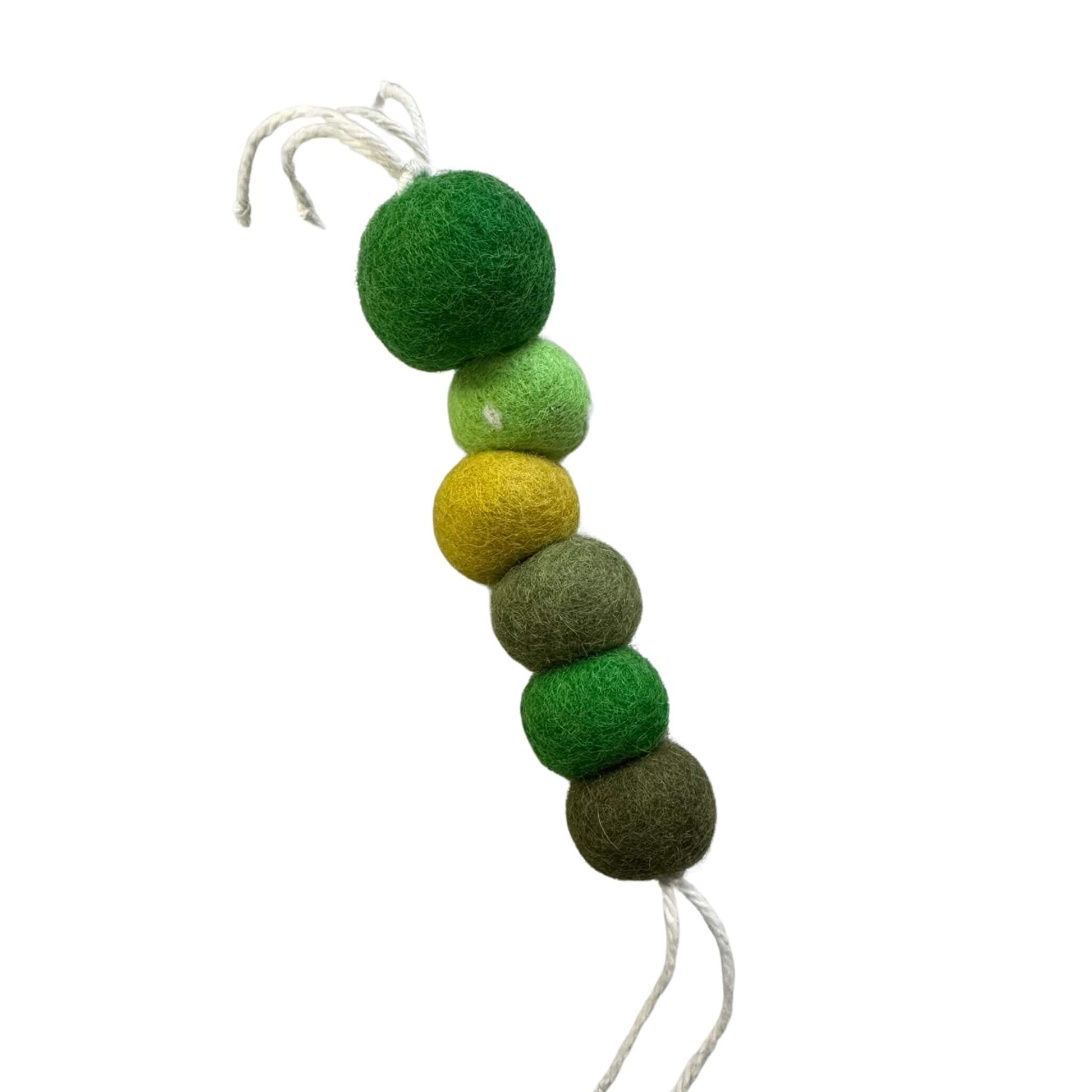 Handcrafted wool worm cat toy in natural green and earth-tone shades. Soft wool texture, sprayed with our signature fresh, aromatic premium catnip. Made by CatnipTakeout