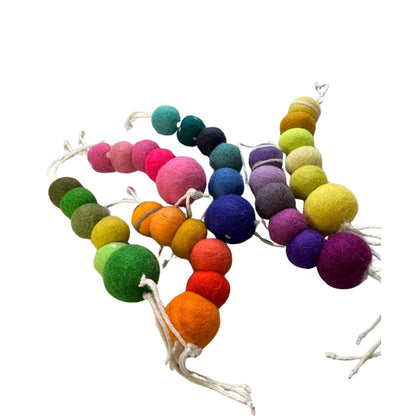 Group of wool worm cat toys displayed in a variety of colors and tones. Each piece is one-of-a-kind, made from soft wool, and sprayed with our signature fresh, aromatic premium catnip. Made by CatnipTakeout.